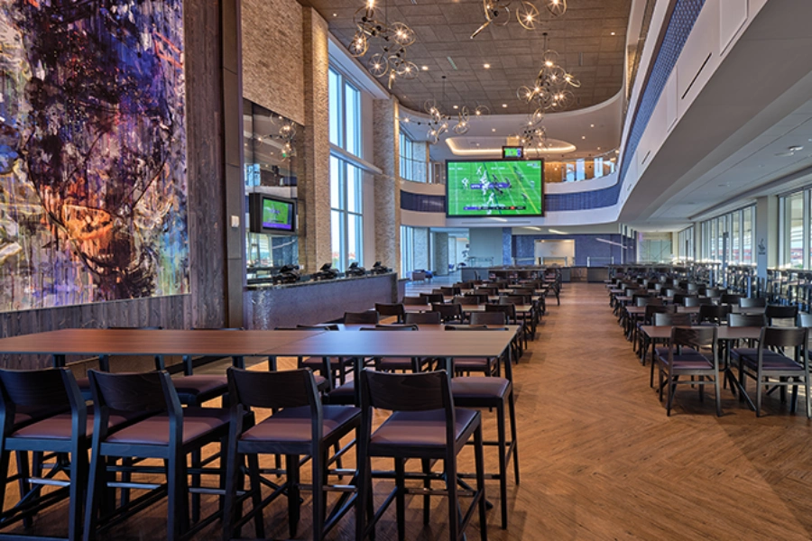Interior view of the Legends Club with round tables and high-top seating options