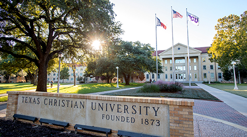 TCU sign in front of Sadler flags